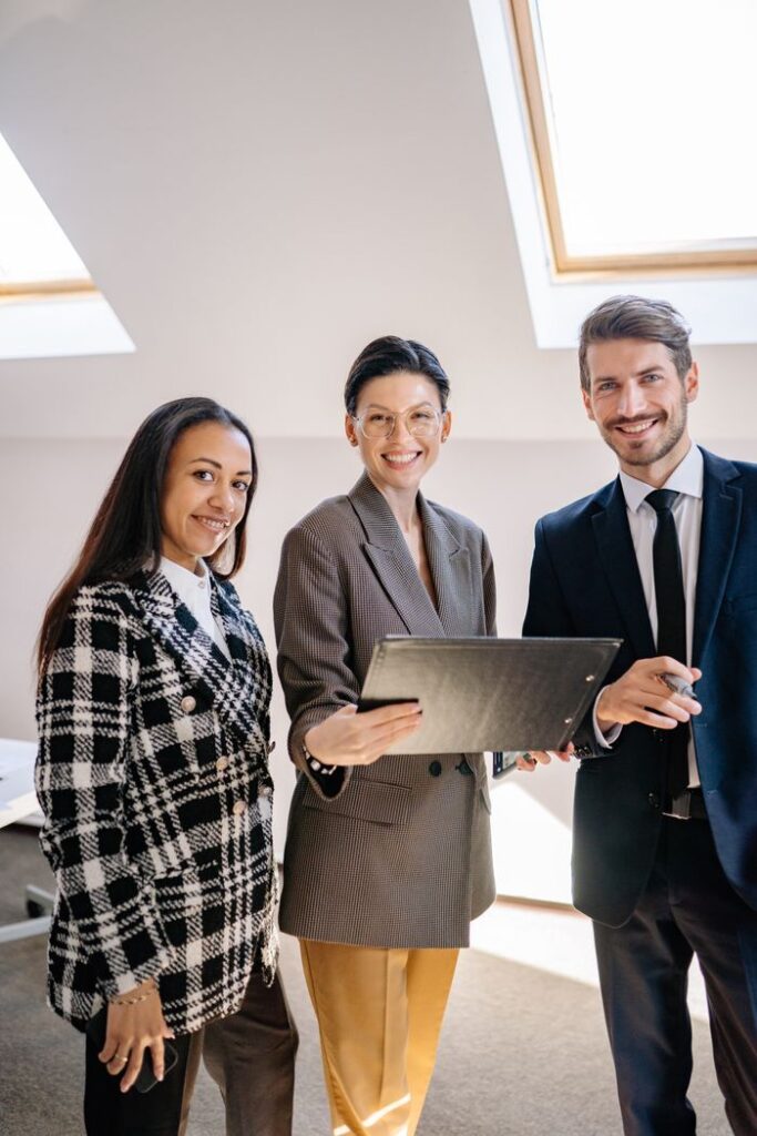 pexels-photo-7693101-7693101 Professional business team smiling together in an office environment.